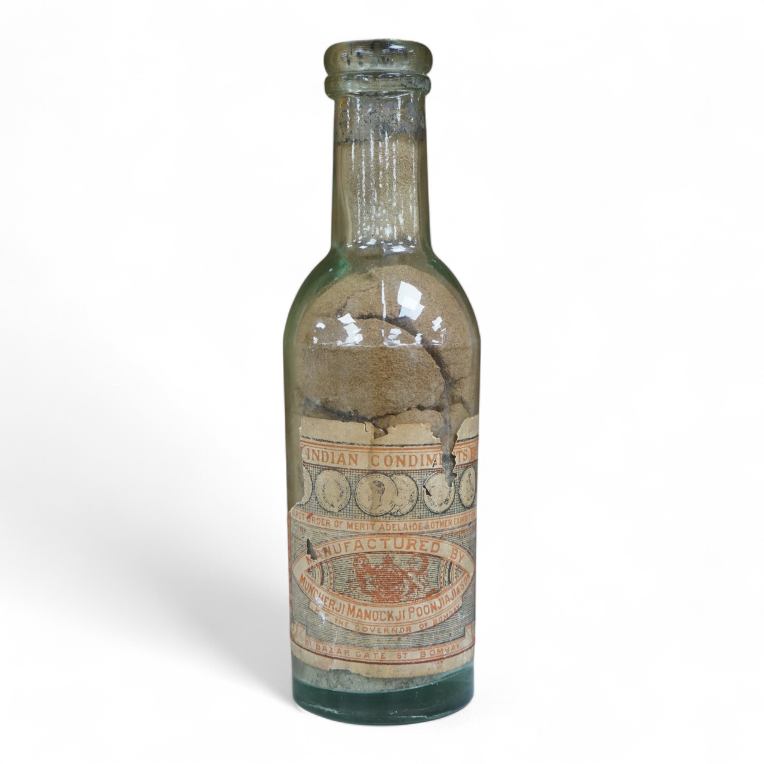 A 19th century sealed bottle of Indian curry powder, with original labels, 28cm high